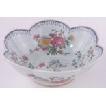 A Chinese porcelain bowl of lobed circular form, hand painted enamel flowers, diameter 20cm.