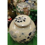 A large blue and white Chinese jar and cover and another with polychrome decoration.