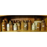 A shelf of Stoneware jars and bottles.