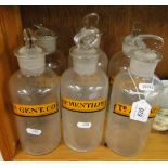 A set of 6 glass pharmacy jars and stopper with labels.