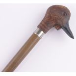 A carved and stained wood duck's head design walking stick, with quacking beak.