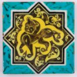 An Islamic hand painted pottery tile, stylised lion design, width 20cm.