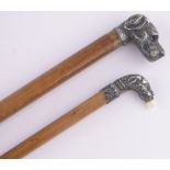 A Victorian Malacca walking cane with unmarked white metal dog's head handle with glass eyes,