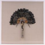 A highly detailed Native American bird feather fan,