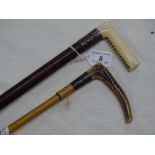 Horn handled riding crop and an ivory handled walking cane