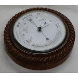 Aneroid barometer and thermometer in rope carved oak case