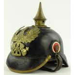 A German Army pickel haube helmet, brass mounted on leather.