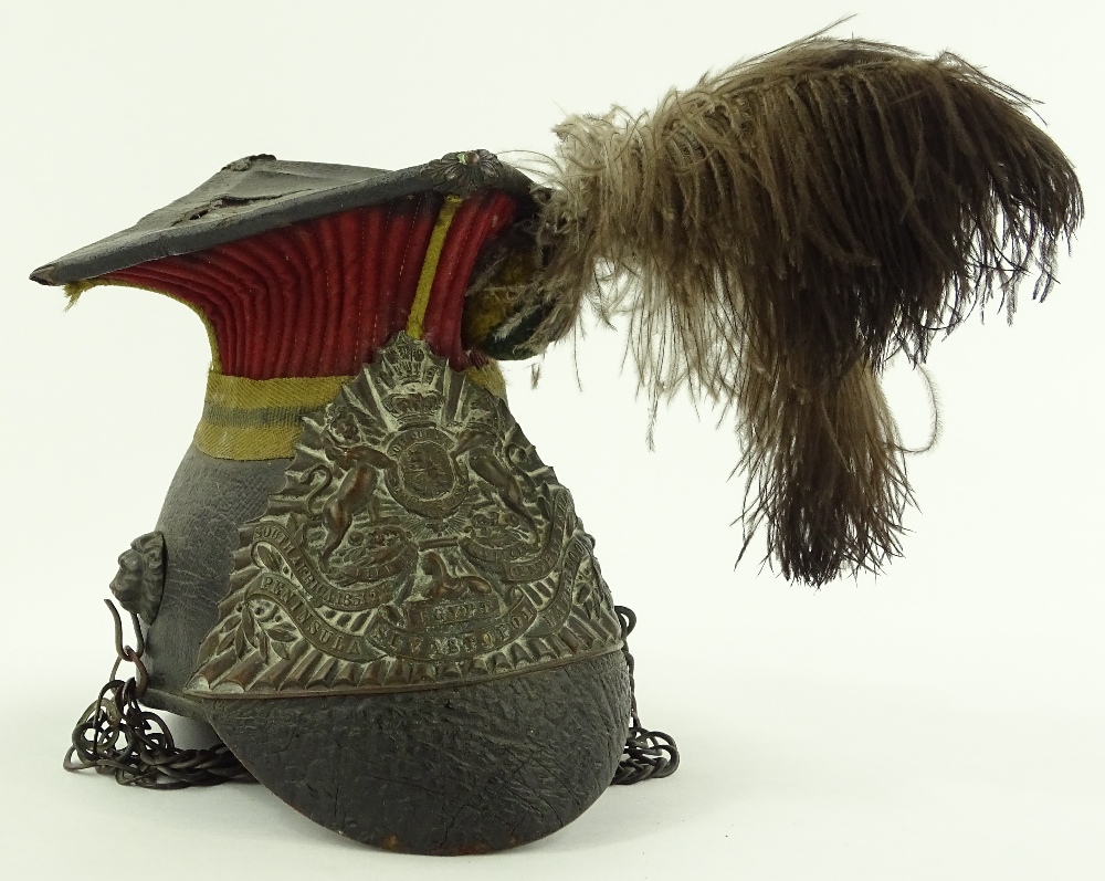 A lancer's helmet, brass mounted on leather with feather plume.
