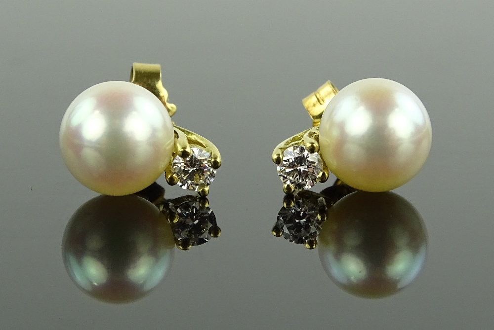 A pair of 18ct gold pearl and diamond stud earrings, pearls 8mm diameter,