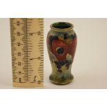 William Moorcroft miniature Pomegranate vase, shouldered ovoid form, mottled blue green ground,