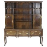George III oak low dresser with later boarded plate rack, the base circa 1760,