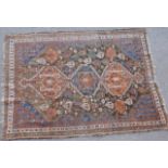 Qashqai woollen rug, central triple pole medallion against a dark field,