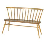 Ercol Shaker style love seat, having a beech spindle rail back, shaped elm seat,