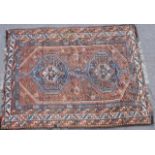 Qashqai woollen rug, madder field with geometrically patterned double pole medallion,