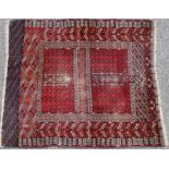 Turkman Hatchli woollen rug, traditional madder field within formalised borders, size approx.
