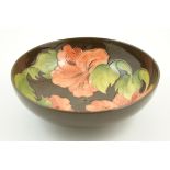 Moorcroft Hibiscus bowl, unusual brown ground, impressed marks and painted initials,