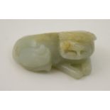 Chinese carved jade figure of a Dog of Fo, recumbent, 19th Century, mutton fat and celadon green,