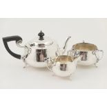 George V silver hand hammered three piece tea service, by Barker Bros.