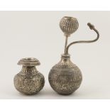 Indian white metal infuser, bottle form with mouth piece and scrolled foliate engraving,
