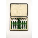 Set of Edwardian silver teaspoons with sugar tongs, Birmingham 1903, cast scroll hafts, cased,