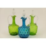 Matched pair of Victorian green tinted glass claret jugs, each with clear drawn handle and stopper,