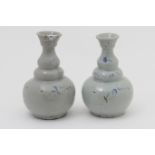 Pair of Annamese pale celadon bottle vases, sparsely decorated with underglaze blue,