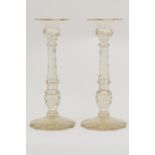 Pair of Victorian cut lead crystal glass candlesticks, with a petalled sconce and faceted column,