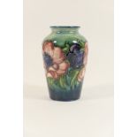 Moorcroft Anemone small shouldered vase, decorated in colours against a shaded blue-green ground,