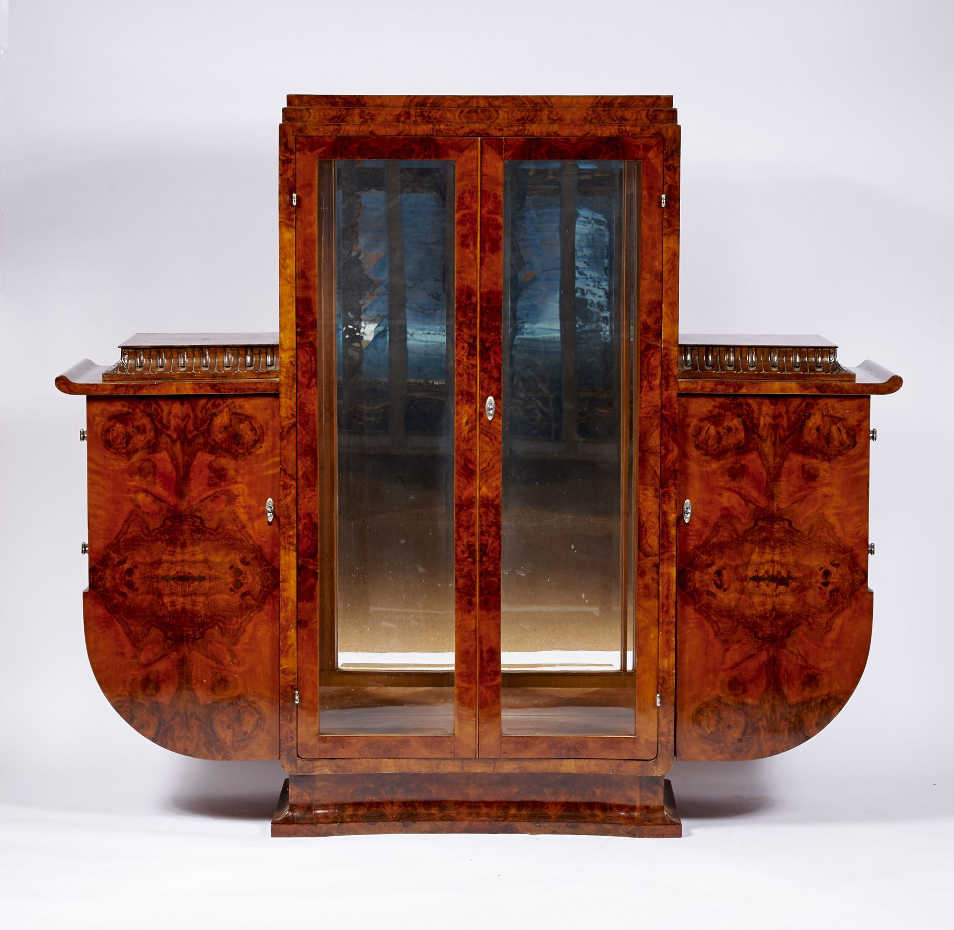 A Display Cabinet Art Deco burr-walnut veneer carved friezes beveled glass chrome metal applications