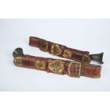 A Pair of cattle Belts with Bells, leather and yellow metal applications "Cartouches", European,