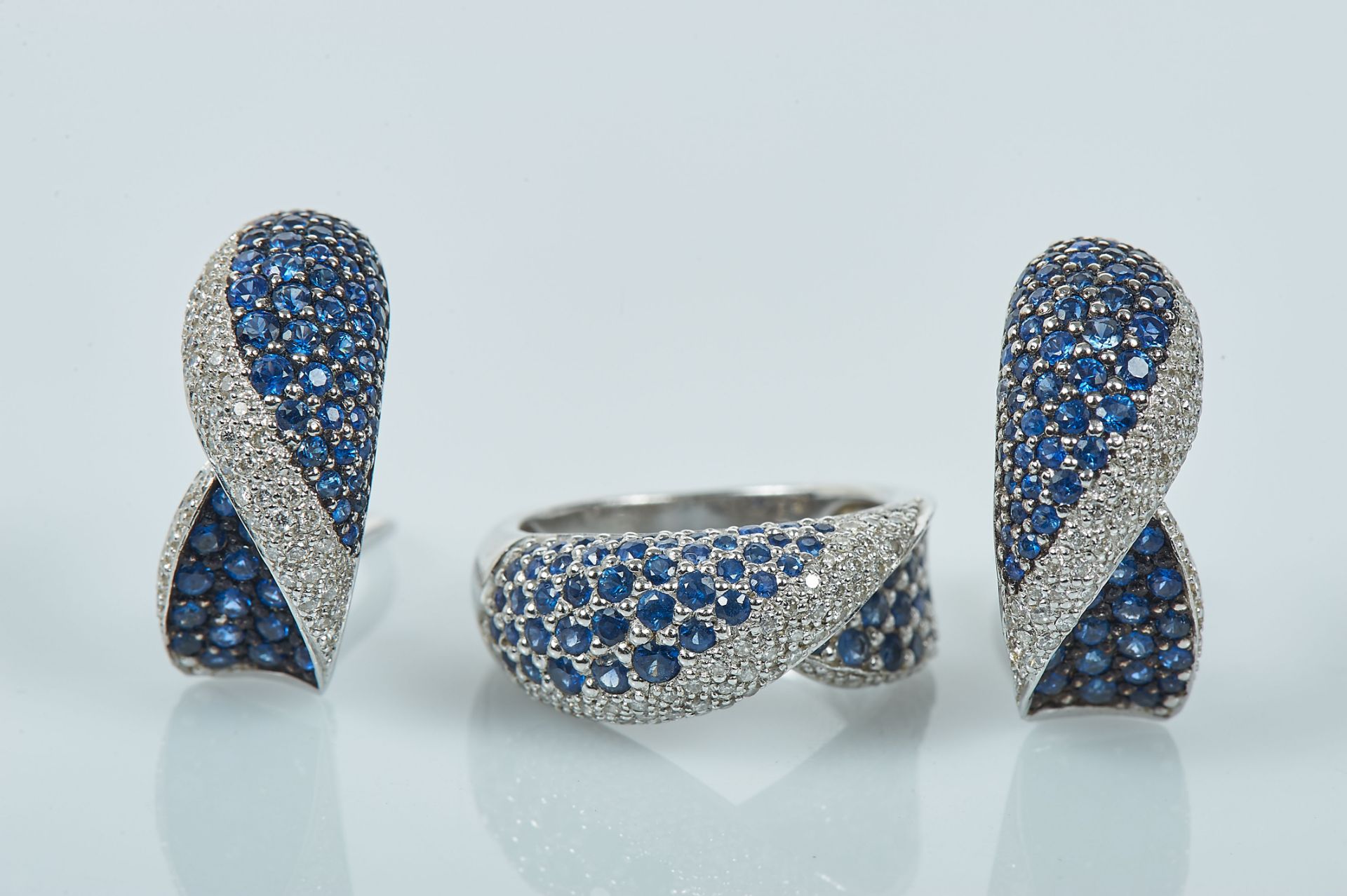 A Ring and a Pair of Earrings, 800/1000 gold, set with 144 sapphires and 174 brilliant cut