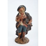 A Fiddle Player, polychrome terracotta sculpture, European, 18th C., a broken and glued arm, missing