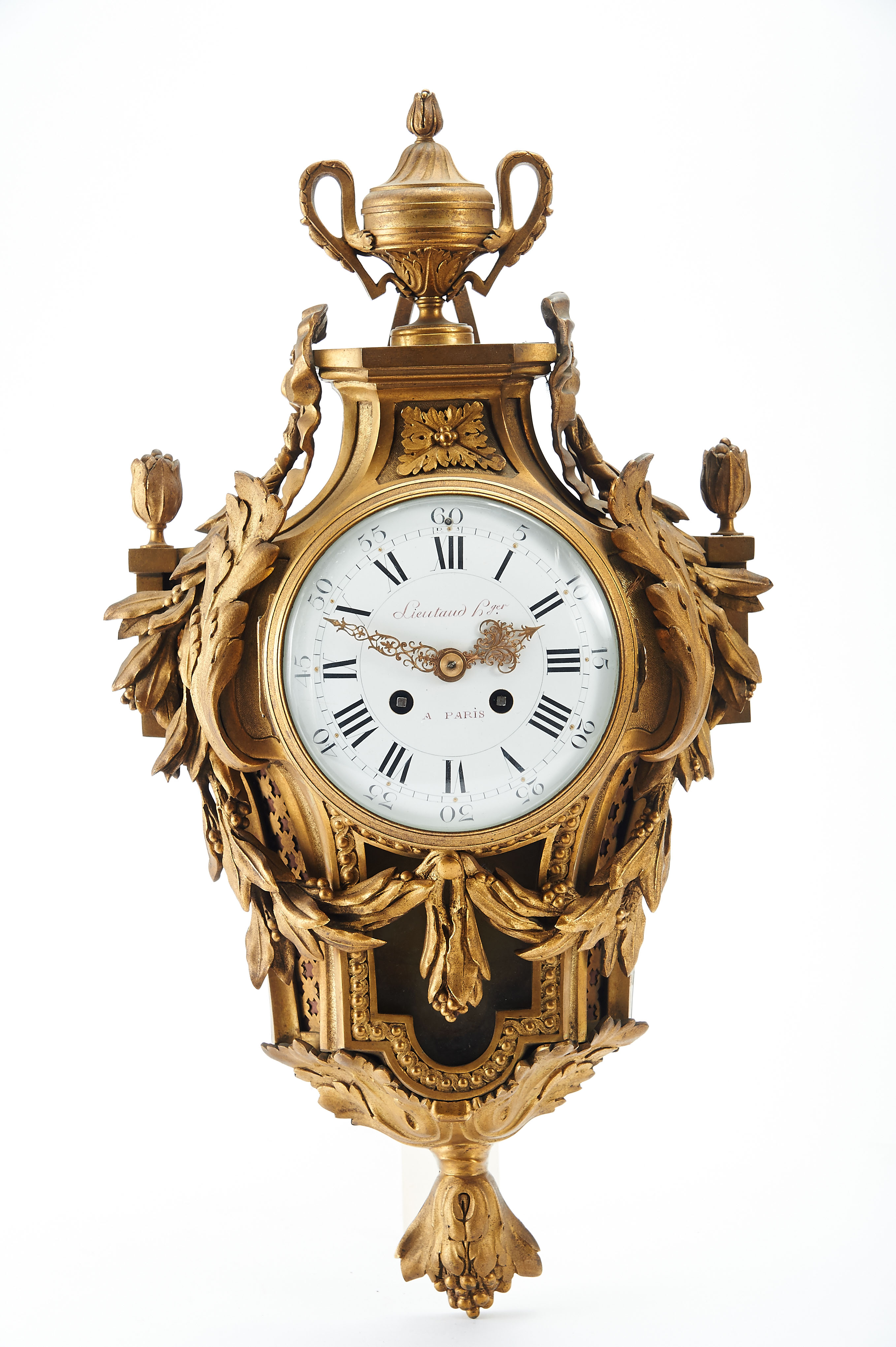 A "Cartel" Wall Clock, Louis XVI style, chiselled and gilt bronze case en relief, enamelld dial with