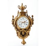 A "Cartel" Wall Clock, Louis XVI style, chiselled and gilt bronze case en relief, enamelld dial with