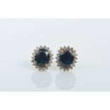 A Pair of Earrings, 750/1000 gold, set with 2 oval cut Australian sapphires with the approximate