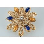 A Brooch, 800/1000 gold, decorated with blue and yellow enamels and set with 1 brilliant cut diamond