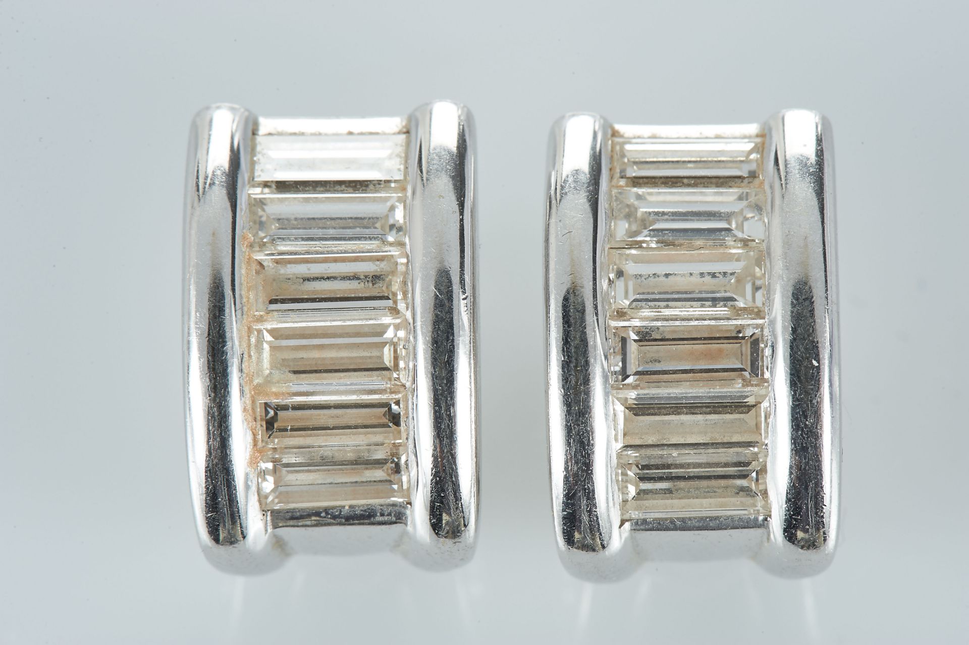 A Pair of Earrings, 800/1000 gold, set with 12 baguette cut diamonds with the approximate weight
