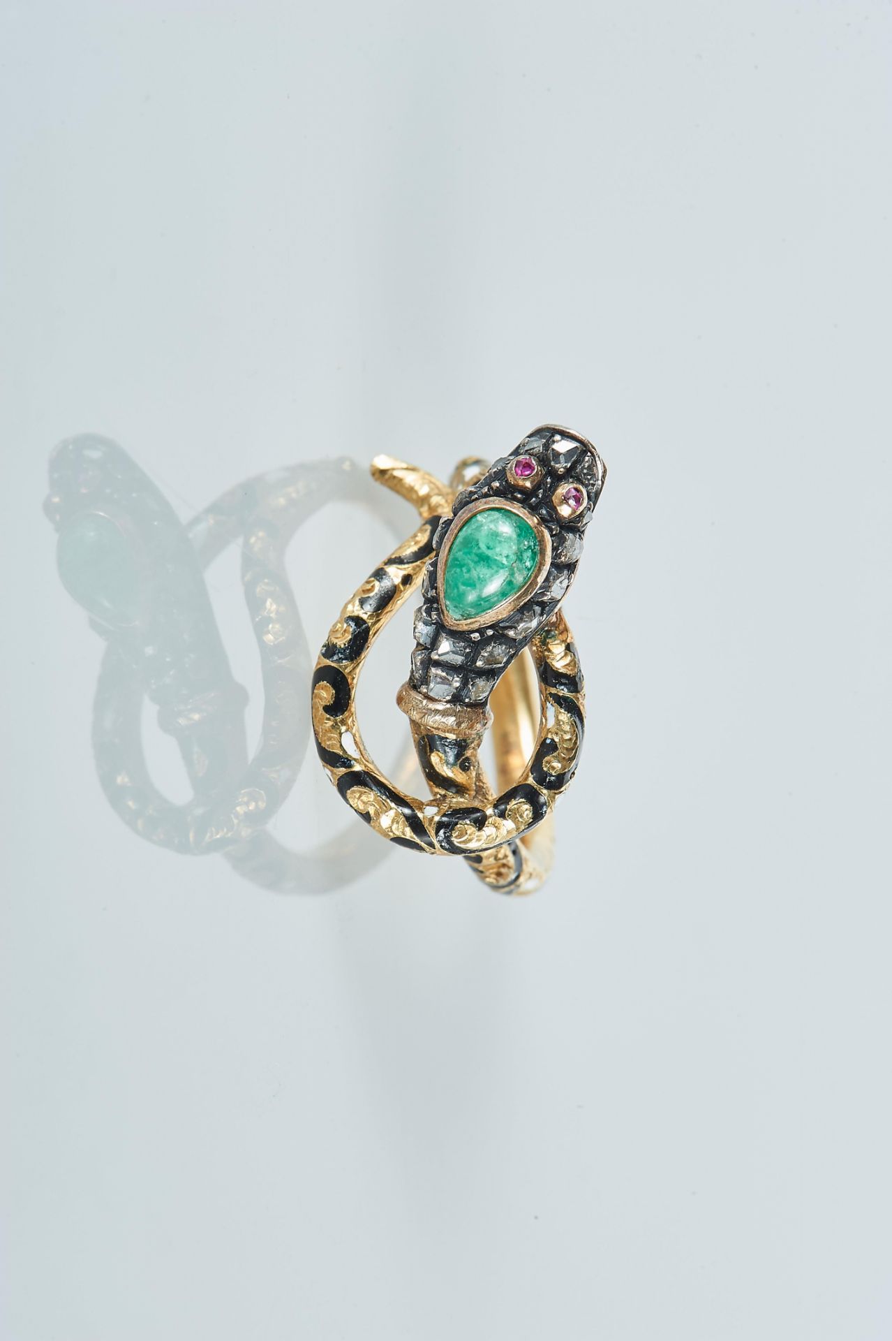 A Ring "Snake", 800/1000 gold and 833/1000 silver, decorated with enamel and set with an emerald,