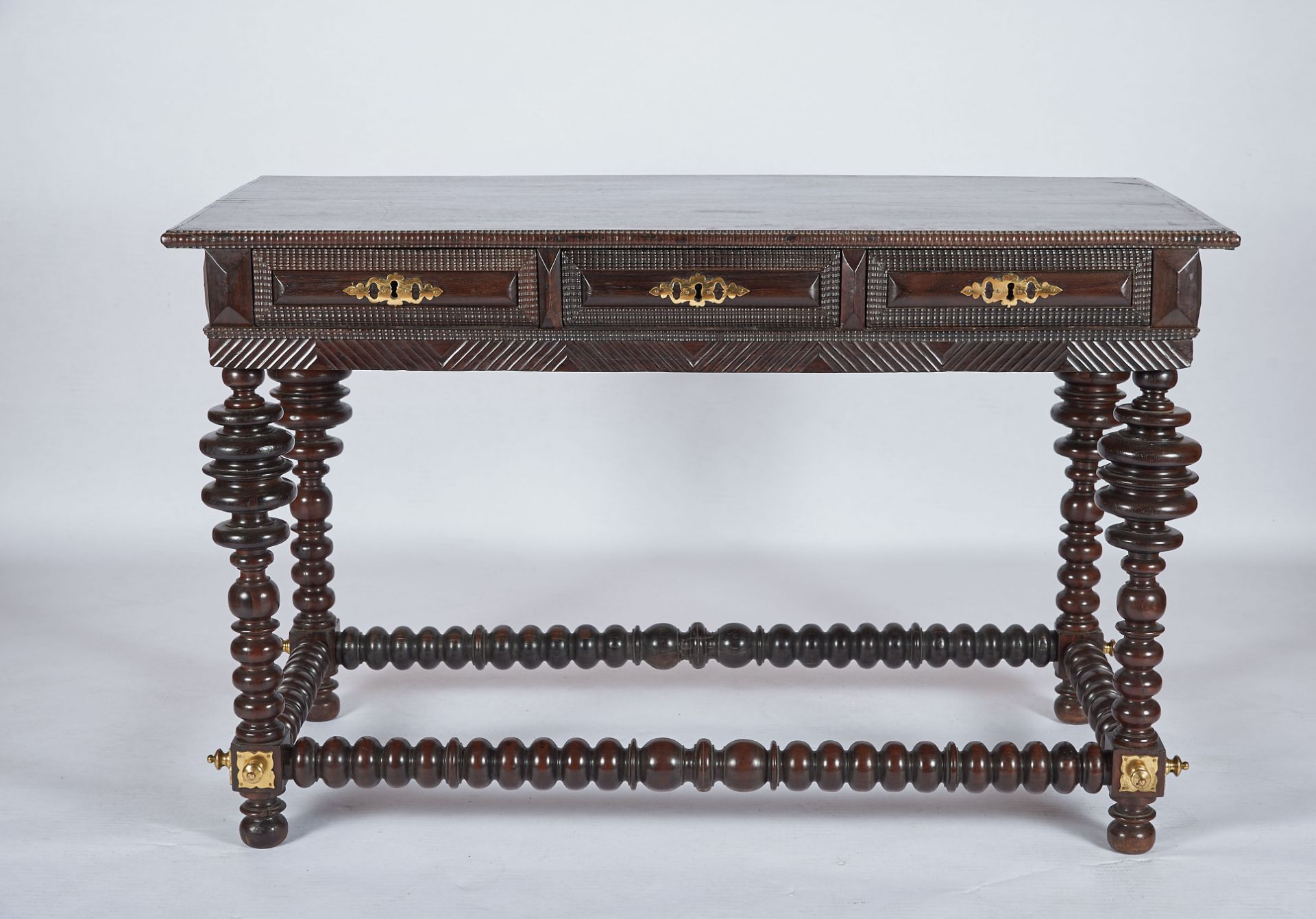 A Centre Table, Brazilian rosewood, black Brazilian chestnut top, ripple moulded friezes, turned