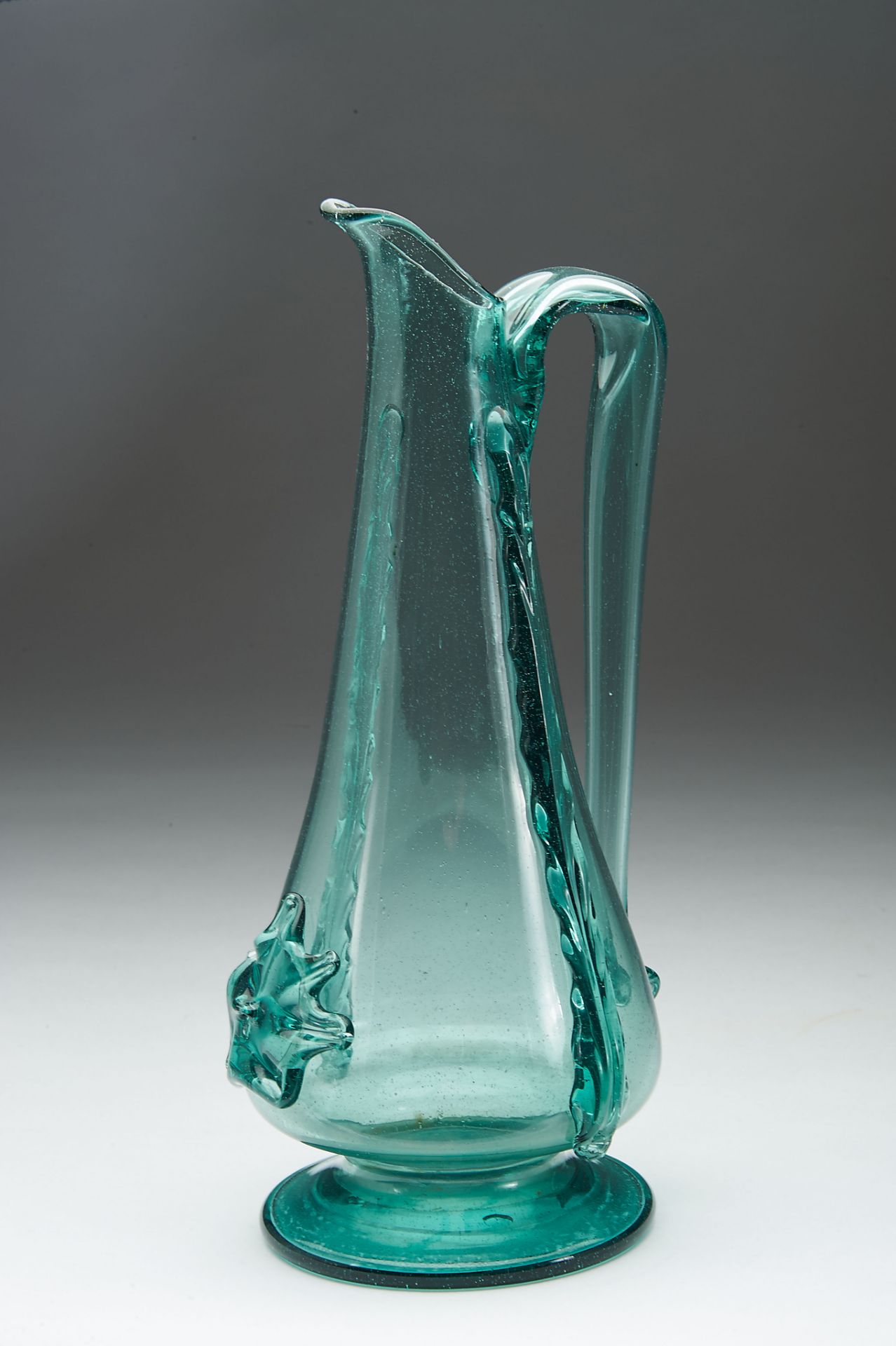A Jug, blown and moulded glass, decoration en relief, Spanish, 18th/19th C., base with hairline,
