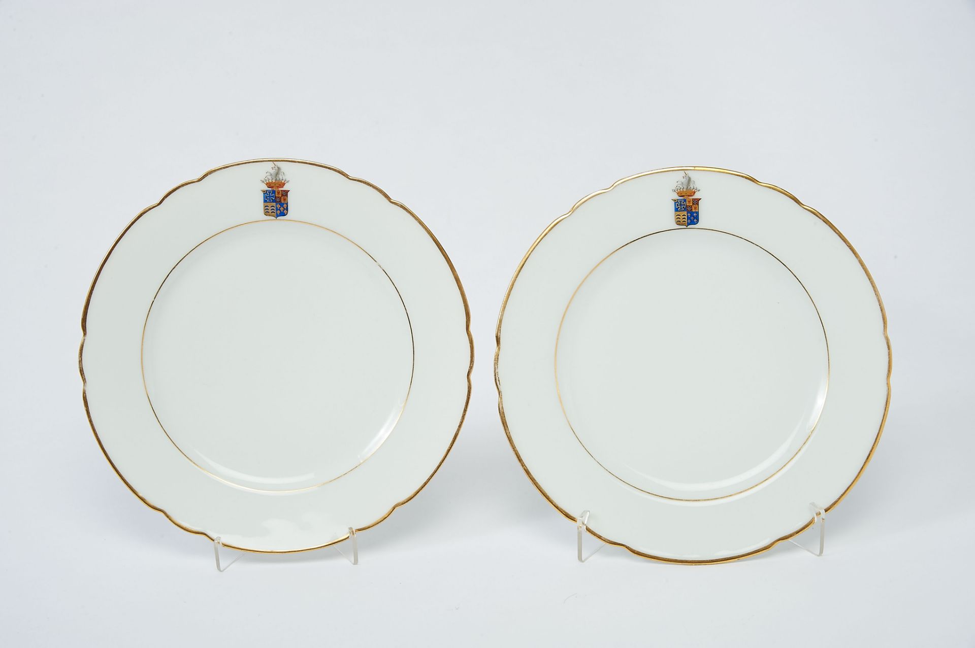 A Pair of Scalloped Dishes, Porcelain, rim with polychrome decoration with the coat of arms of the