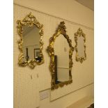 An 18th century-style moulded gilt wall mirror, 41in., and a pair of smaller similar mirrors