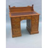 A Victorian oak clerk's desk, sloping top with inset rexine, kneehole arrangement of seven