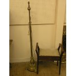 An Edwardian inlaid mahogany piano stool, with hinged, upholstered seat, and a brass floor lamp,