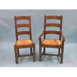 A set of eight French oak dining chairs, including pair of carvers, bar-backs with rush seats