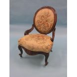 A Victorian mahogany spoon-back elbow chair, frame deeply-carved, on front cabriole legs with