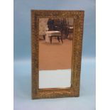 A Victorian giltwood mirror, rectangular-shape with carved twists and cusped gothic arches, original
