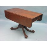 An early 19th century mahogany drop-leaf breakfast table, with single drawer, pedestal stem and four