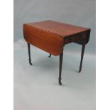 An early 19th century mahogany Pembroke table, with single frieze drawer, on reeded, tapering legs