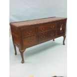 An Edwardian mahogany sideboard, two long and two short drawers, further cellarette drawer, cabriole